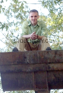 Tyler sitting in the front bucket of the backhoe, lifted in the air the day his trial ended.